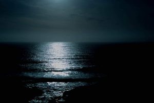 A picture of the dark ocean at night.