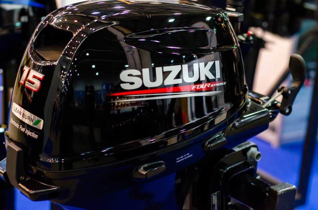 A new and shiny black Suzuki outboard engine is shown.