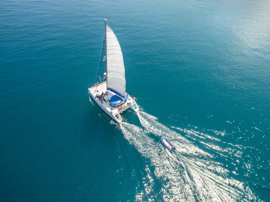 A catamaran sailboat traverses the southern seas. Read all about catamarans at Boating.Guide.