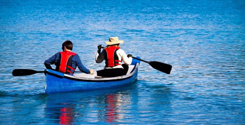 Two people paddling out in a canoe